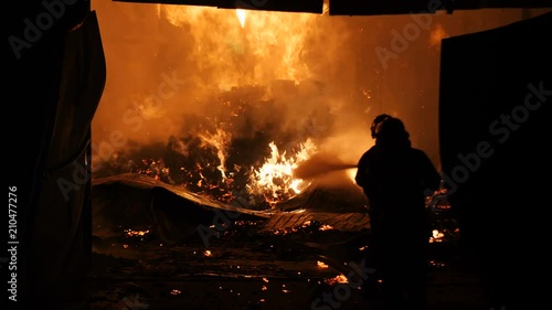 Firefighters Spraying Water Onto Fully Engulfed Building Slow Motion 4K 2