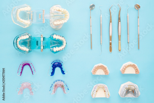 dentist tools and orthodontic on the  blue background, flat lay, top vipw. photo