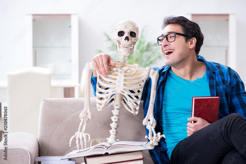 Student studying with skeleton preparing for exams Student studying with skeleton preparing for exams