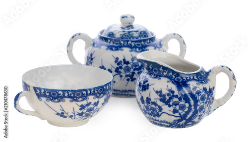 Traditional russian set for tea with blue floral painting in Gzhel style. There are cup, sugar bowl, creamer  isolated on white background. photo