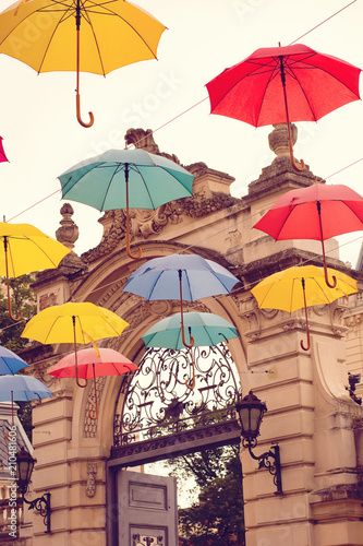 Multi-colored umbrellas background. Colorful umbrellas floating above the street. Street decoration.