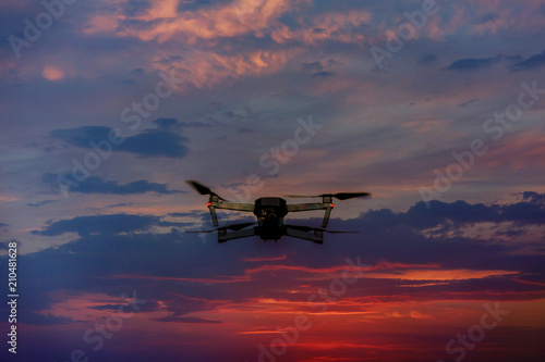 Drone flying over a sunset sky with light clouds