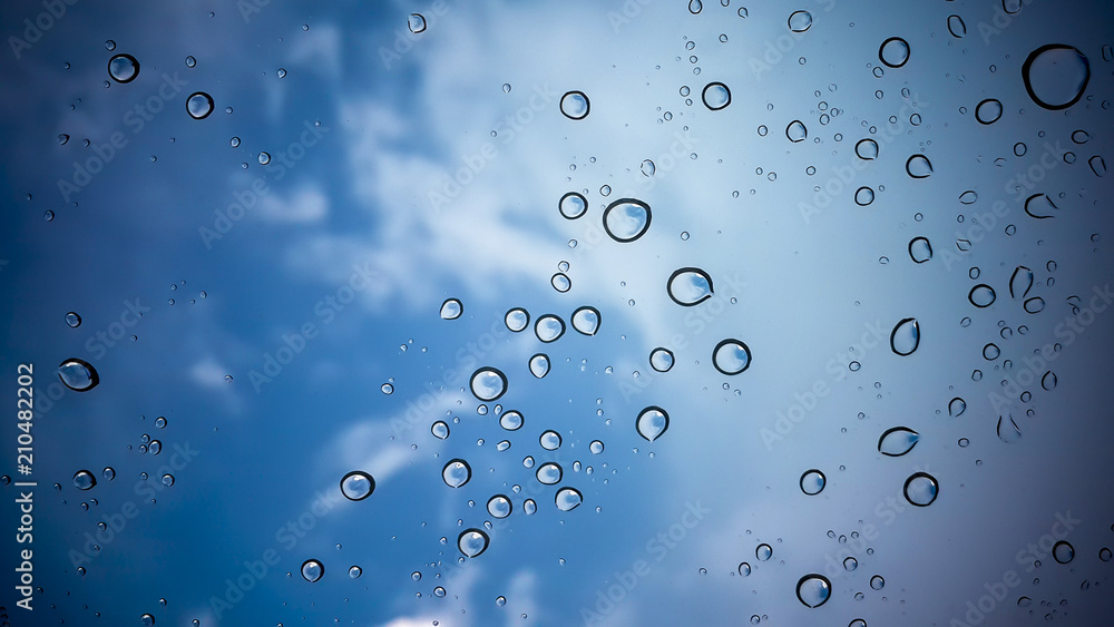 Natural water drop on sky background.
