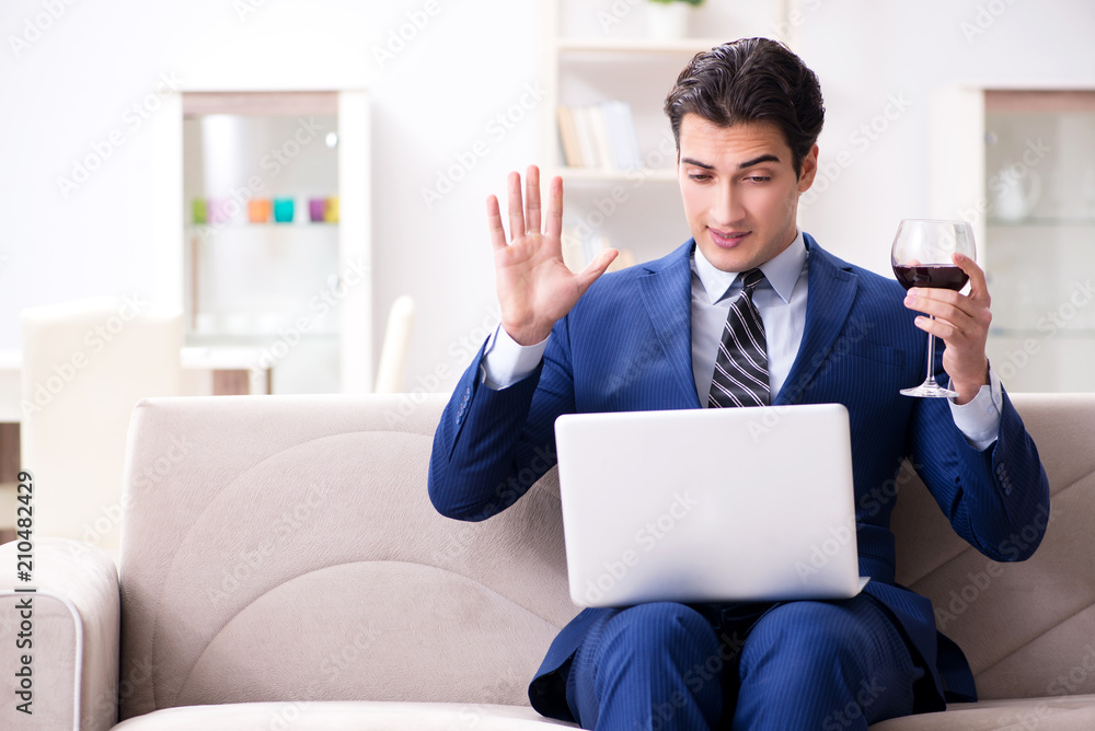 Businessman drinking wine sitting at home Businessman drinking wine sitting at home