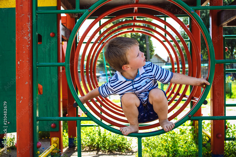 Little boy playing on the playground. The child is in a circle. Little boy playing on the playground. The child is in a circle.
