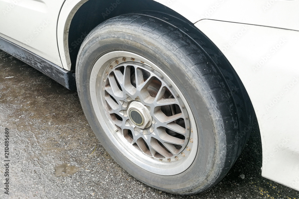 Car with worn bald tire unsafe and poses accident risk