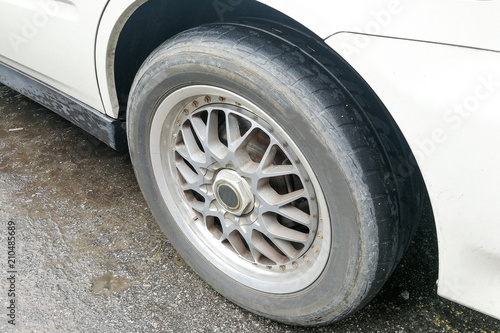 Car with worn bald tire unsafe and poses accident risk © ThamKC