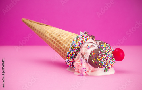 Melting Ice Cream in a Cone with Chocolate and a Cherry on Top