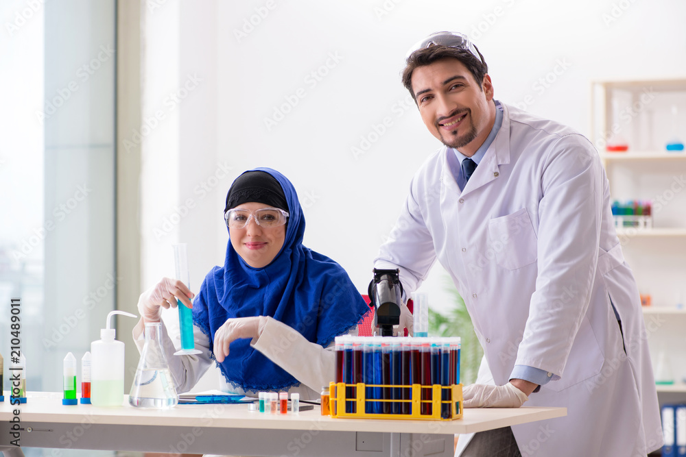 Two chemists working in the lab Two chemists working in the lab