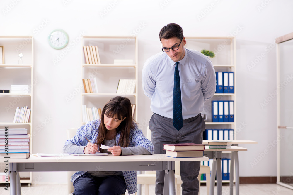 © Elnur - Male lecturer giving lecture to female student