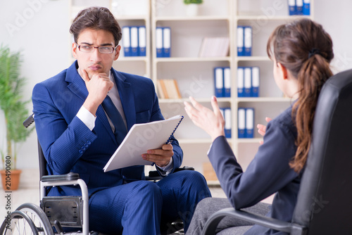 Disabled businessman having discussion with female colleague
