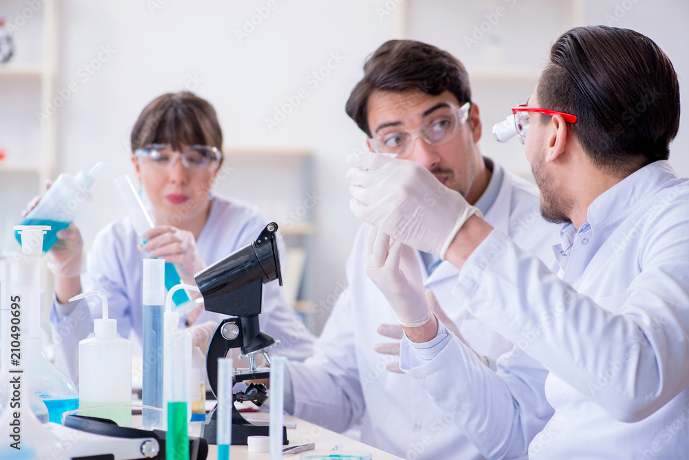 Team of chemists working in the lab Team of chemists working in the lab