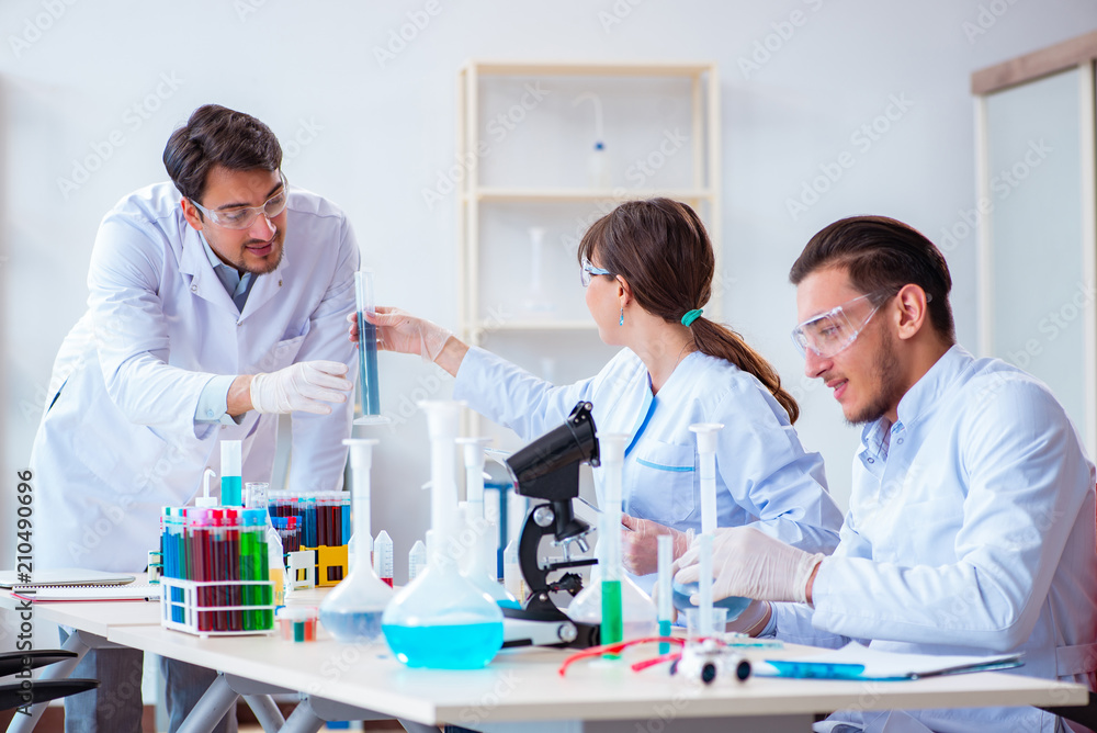 Team of chemists working in the lab Team of chemists working in the lab