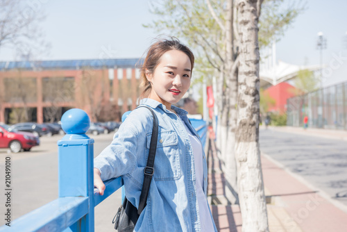 College Girl With Backpack on Campus. Asian chinese college female student 