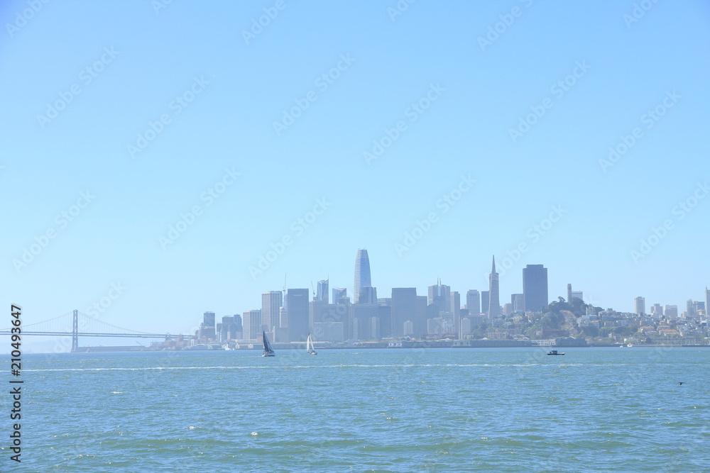 Silhouette of San Francisco’s Skyline with Yacht Sailing in the Harbor Silhouette of San Francisco’s Skyline with Yacht Sailing in the Harbor