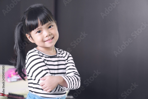 Fotografie Asian children cute or kid girl feel business child with cross one's arm and smi