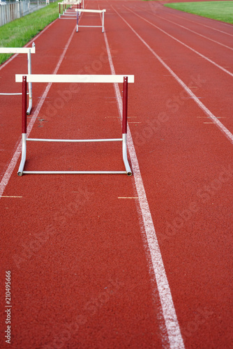 hurdles in a row on red sport field