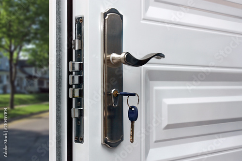 Open door of a family home. Close-up of the lock with your keys on an armored door. Security.