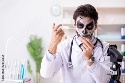 Scary monster doctor working in lab photo