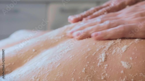 Wallpaper Mural Young woman having scrubbing massage in beauty spa salon close-up in slow motion Torontodigital.ca