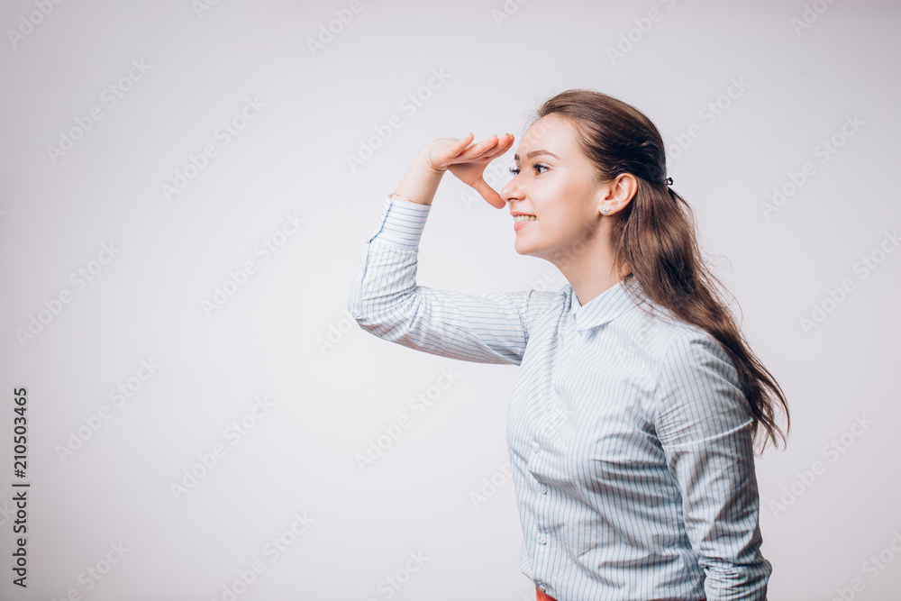 Joyful young woman holding hand on forehead, looking away and smiling. Side view. Joyful young woman holding hand on forehead, looking away and smiling. Side view.
