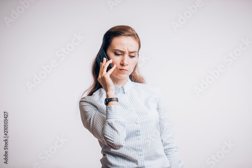 Beautiful business woman talking on a smartphone, listening to the client.