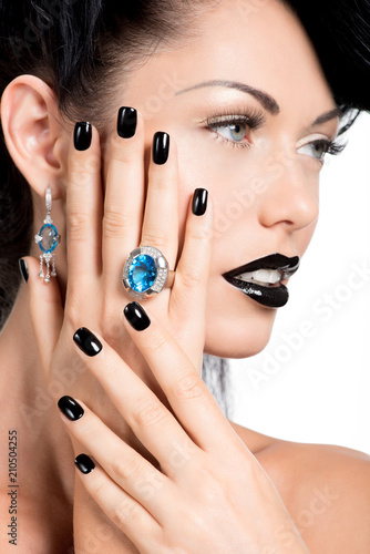 Glamour woman's nails , lips and eyes painted color black.