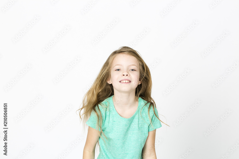 beautiful young girl is happy and dancing and posing in the studio in front of white background beautiful young girl is happy and dancing and posing in the studio in front of white background