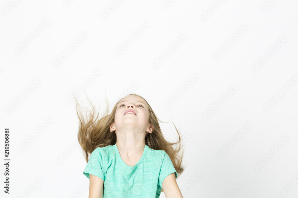 beautiful young girl is happy and dancing and posing in the studio in front of white background beautiful young girl is happy and dancing and posing in the studio in front of white background
