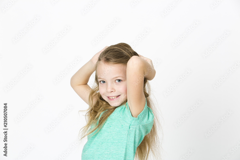 beautiful young girl is happy and dancing and posing in the studio in front of white background