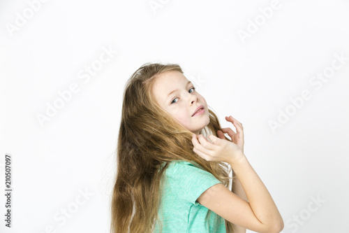 beautiful young girl is happy and dancing and posing in the studio in front of white background