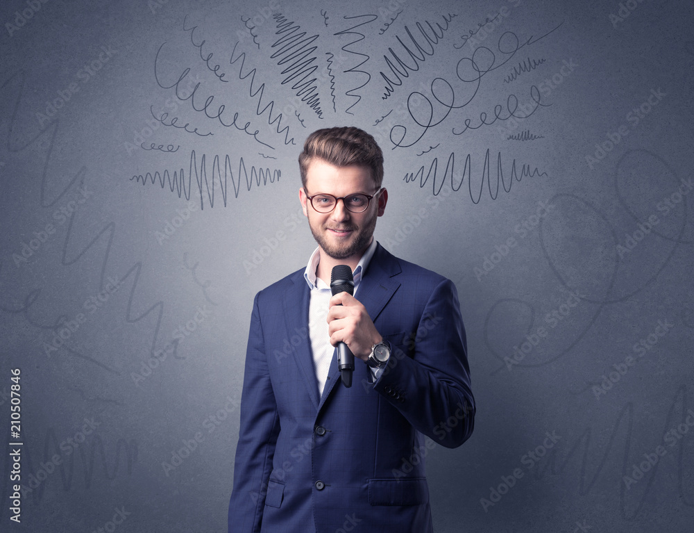 Businessman speaking into microphone with scribbles over his head Businessman speaking into microphone with scribbles over his head