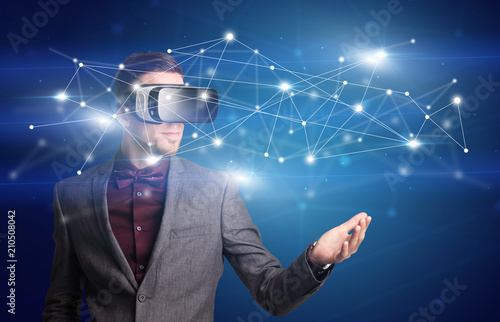 Amazed businessman with virtual reality network concept in front of him
