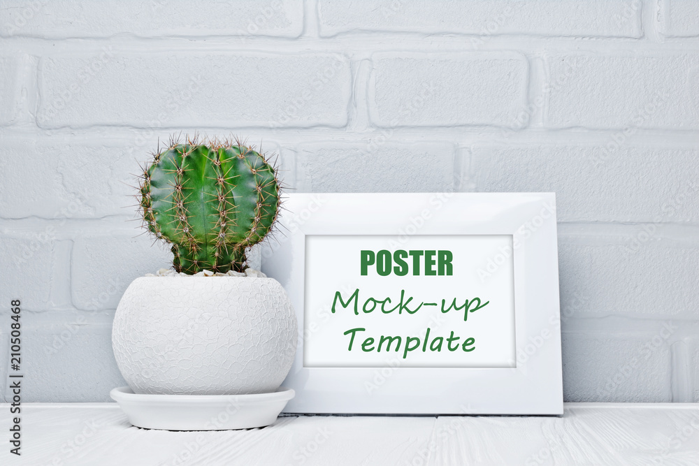 Plakat Small cactus in flower pot and mock-up of white frame with copy space for poster