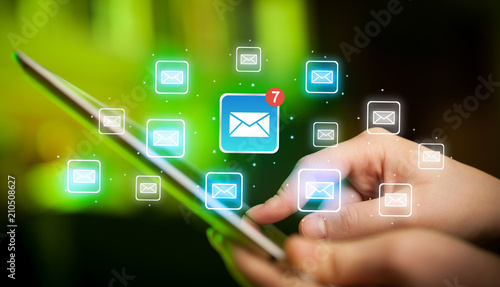 Female hands touching tablet with e-mail icons 