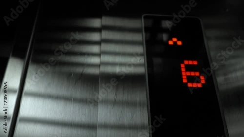 In elevator of modern business center on electronic LCD display. View of the panel with the number and steel silver lining. The monitor shows the number four, five, six, 4, 5, 6.