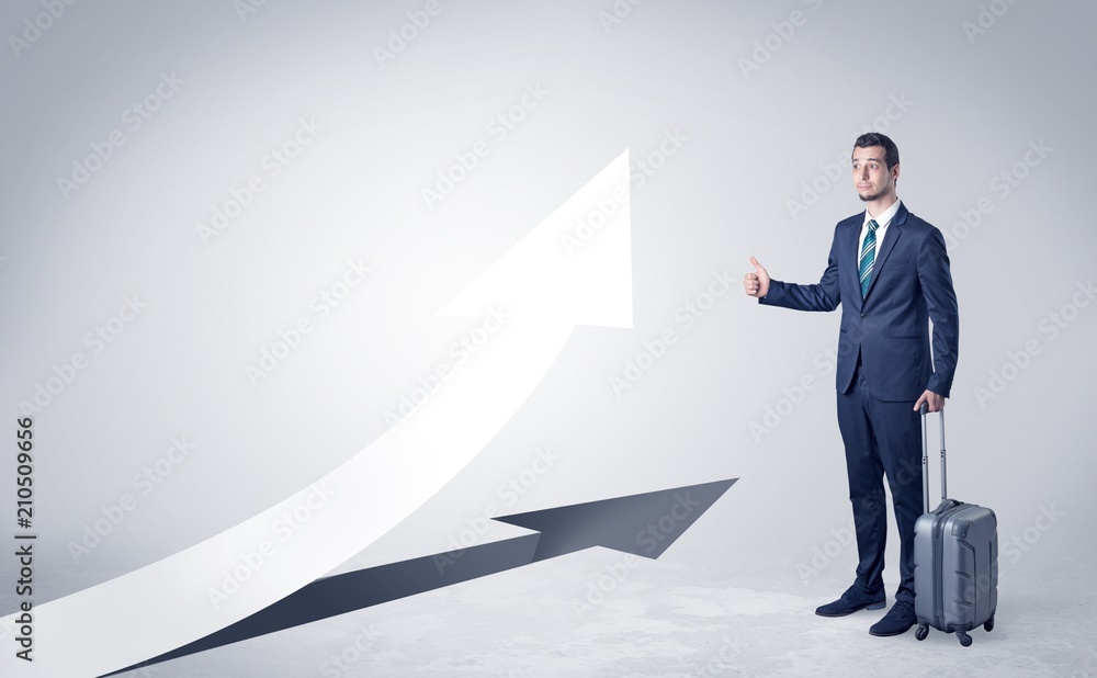 Obraz premium Young businessman hitchhiking with progressive arrow concept and copyspace