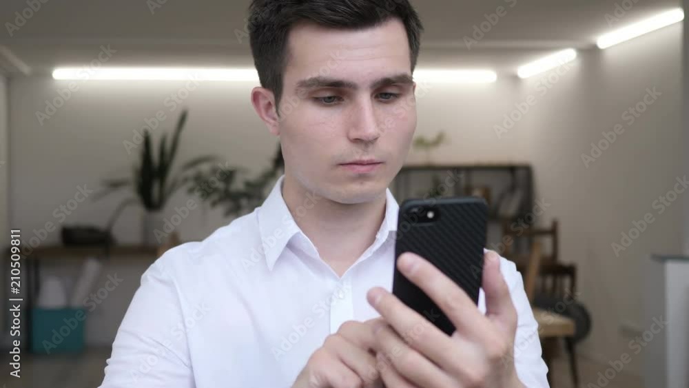 Businessman Using Smartphone in Office Businessman Using Smartphone in Office