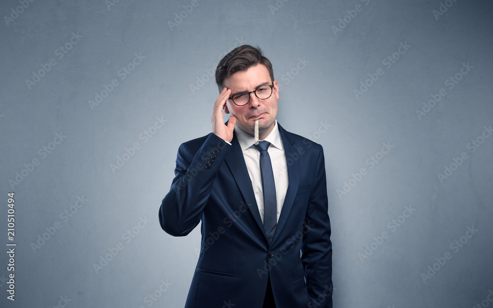 Young tired businessman with thermometer and copy space
Young tired businessman with thermometer and copy space