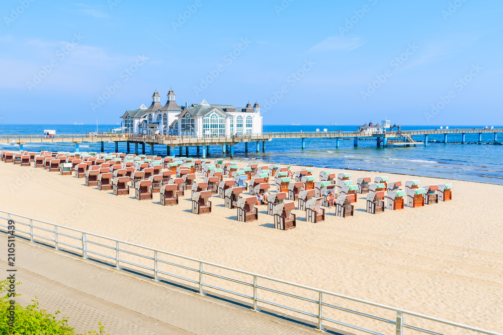 View of pier with historic building on sandy beach in Ostseebad Sellin, Ruegen island, Baltic Sea, Germany