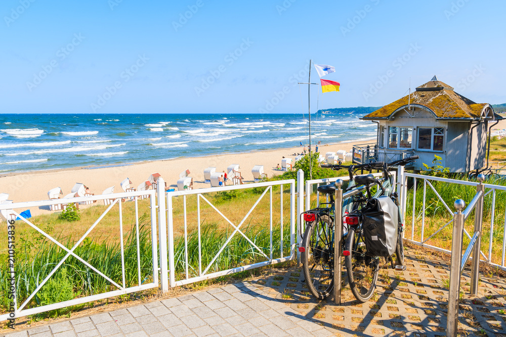 SELLIN, RUEGEN ISLAND - MAY 29, 2018: Bicycle parked terrace overlooking beach in Sellin town on Baltic Sea coast, Germany. Ruegen is popular tourist destination because of its long sandy beaches. SELLIN, RUEGEN ISLAND - MAY 29, 2018: Bicycle parked terrace overlooking beach in Sellin town on Baltic Sea coast, Germany. Ruegen is popular tourist destination because of its long sandy beaches.