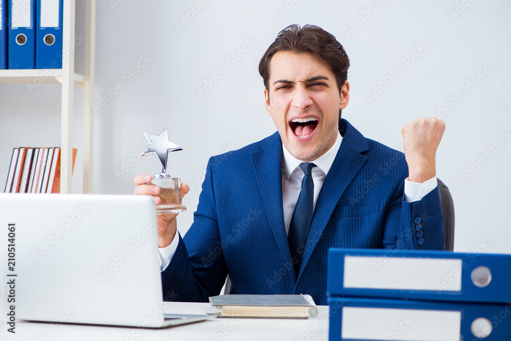 Young handsome businessman employee working in office at desk Young handsome businessman employee working in office at desk