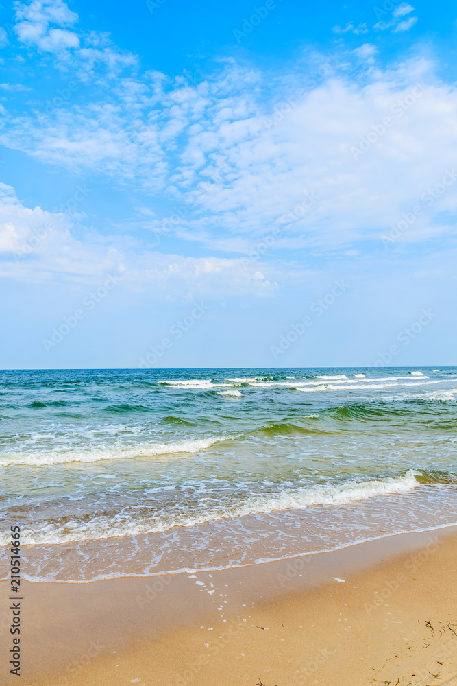 Sea waves on beach in Baabe summer resort from sand dune, Ruegen island, Baltic Sea, Germany
