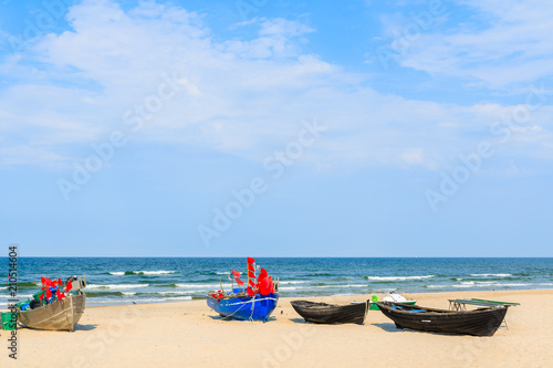 Traditional fishing boats on sandy beach in Baabe town, Ruegen island, Baltic Sea, Germany