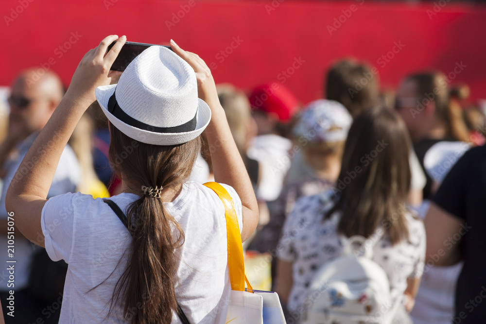 Fototapeta premium Football fans in the fan zone watching the match on the screen