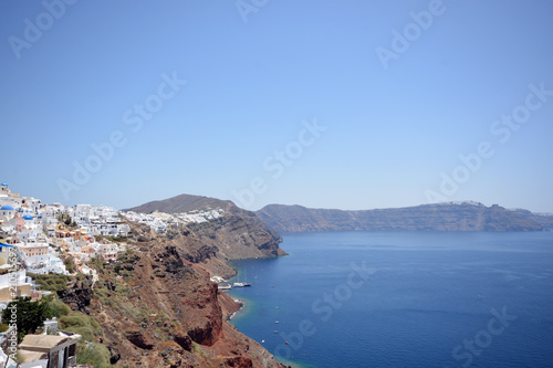 Panoramic view, Santorini island, Traditional and famous white houses and churches with blue domes over the Caldera, Aegean sea.