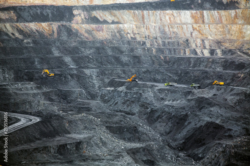 Quarry for coal mining. Autumn landscape. Heavy mining industry.