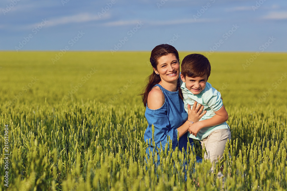 Mother and son play fun in the field of wheat in nature. Mother and son play fun in the field of wheat in nature.