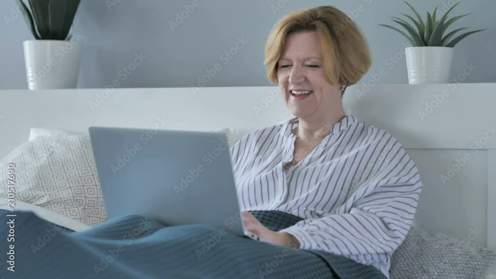 Online Video Chat by Excited Old Senior Woman Lying on Stomach in Bed Online Video Chat by Excited Old Senior Woman Lying on Stomach in Bed