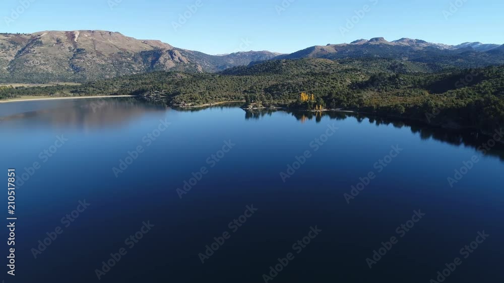 Aerial drone scene Alumine lake villa pehuenia. Camera travels very high towards the coast. Big perspective of mountains, woods, coast, beach. Yellow poplars. Mapuche area, five lagoons touristic zone Aerial drone scene Alumine lake villa pehuenia. Camera travels very high towards the coast. Big perspective of mountains, woods, coast, beach. Yellow poplars. Mapuche area, five lagoons touristic zone